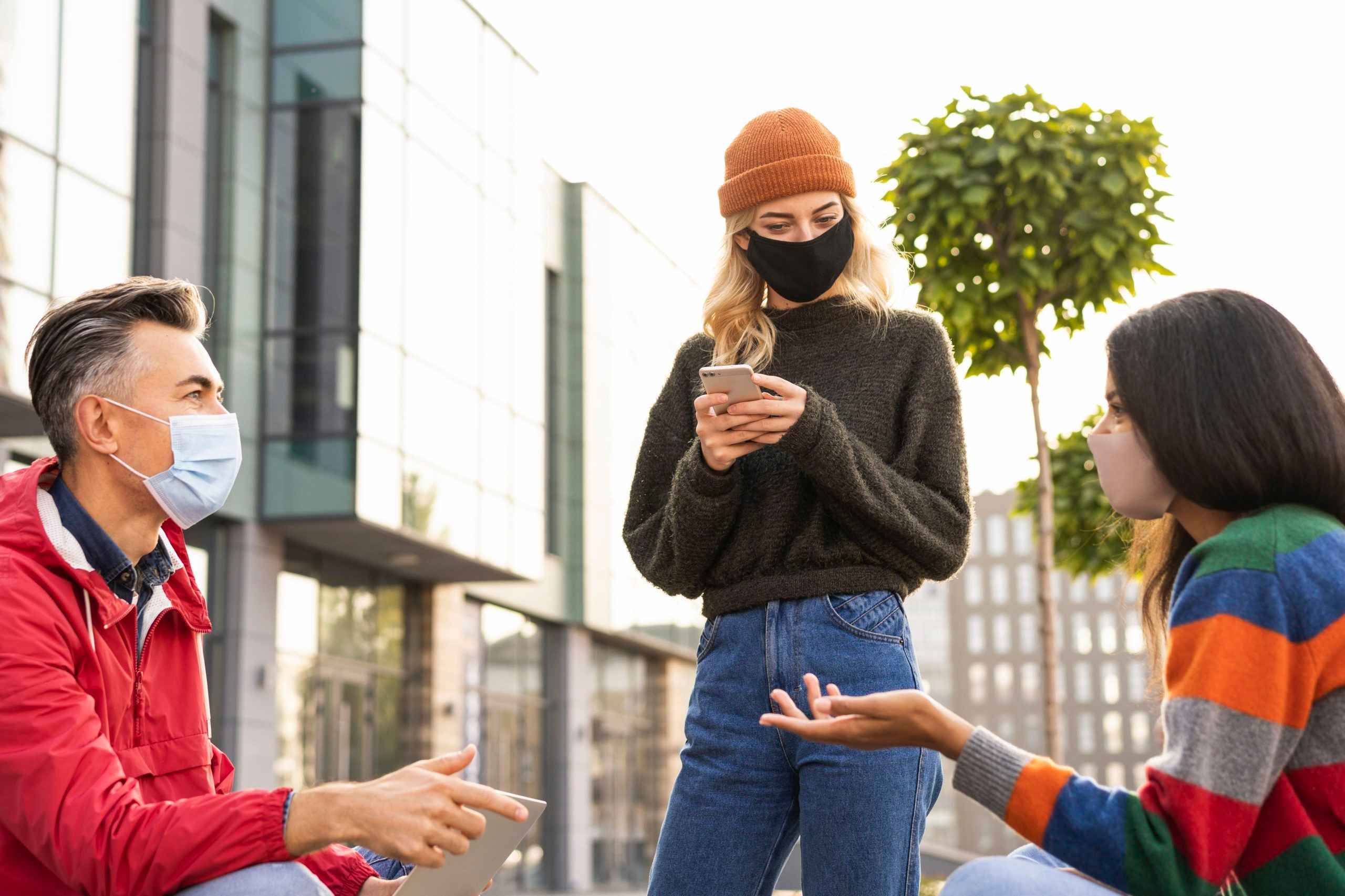 Teenagers discussing while wearing mask